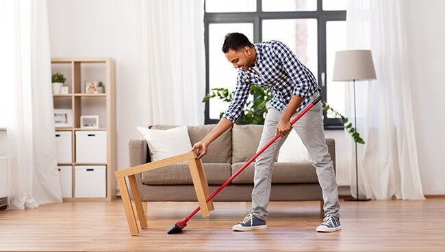 Man cleaning vinyl flooring | Carpets To Go